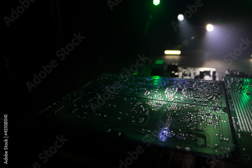 Stylized photo of an electronic microcircuit. Microcircuit, contacts, electronics, motherboard. Black background. Macro photography of electronic devices.