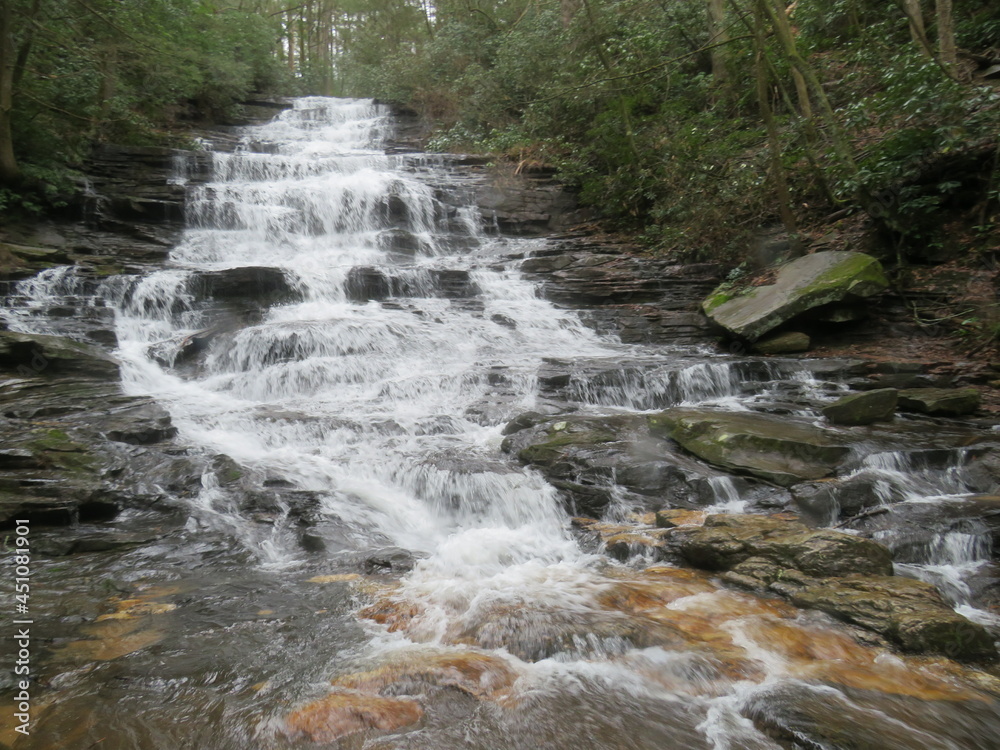 Cascading rocky waterfall in the mountains Cascading rocky waterfall in the mountains