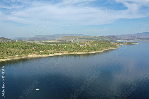 Aerial view of Lake Granby, Colorado and surrounding mountains and forests on calm sunny summer morning.