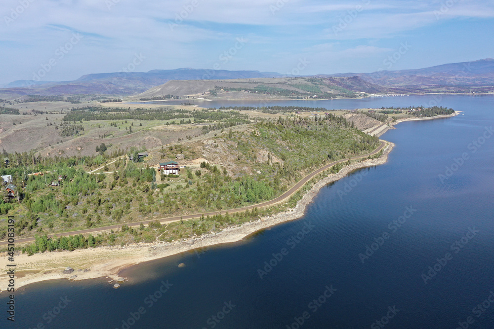 Aerial view of Lake Granby, Colorado and surrounding mountains and forests on calm sunny summer morning.
