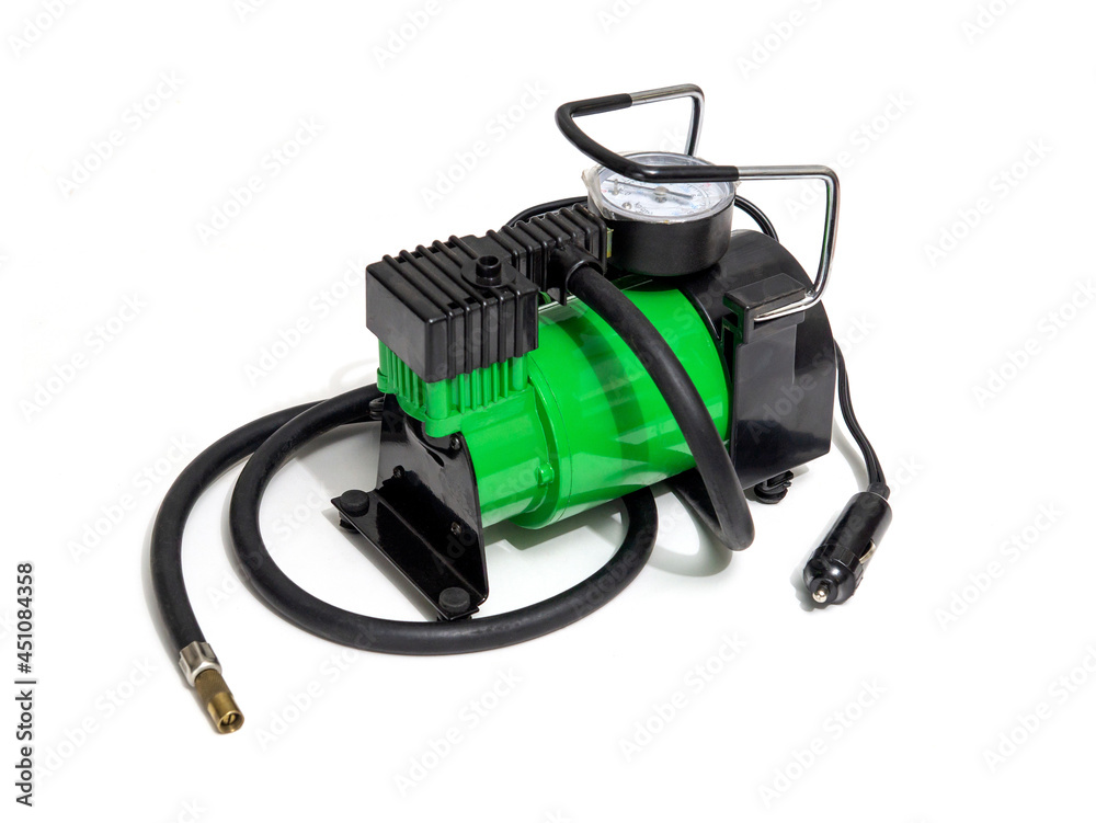 Car pump with manometer, green air compressor on white background. Inflating the wheels with air in the car Car pump with manometer, green air compressor on white background. Inflating the wheels with air in the car