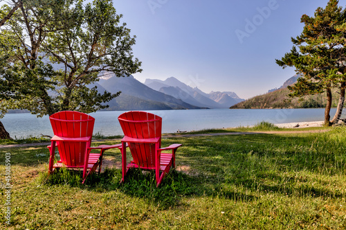 Adirondack chairs on the beach along the shores of Waterton Lake