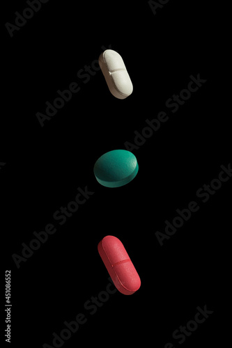 three pills on a black background
