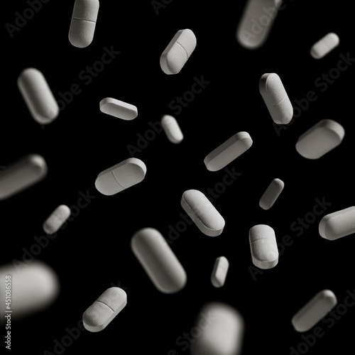 many white pills on a black background