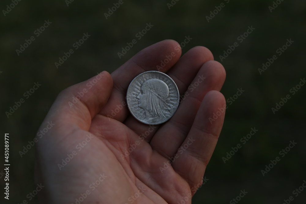 Old silver Polish coin in hand