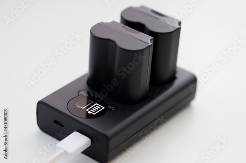 Closeup of black camera battery charger with cable