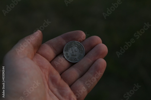 Old Arab coin in hand