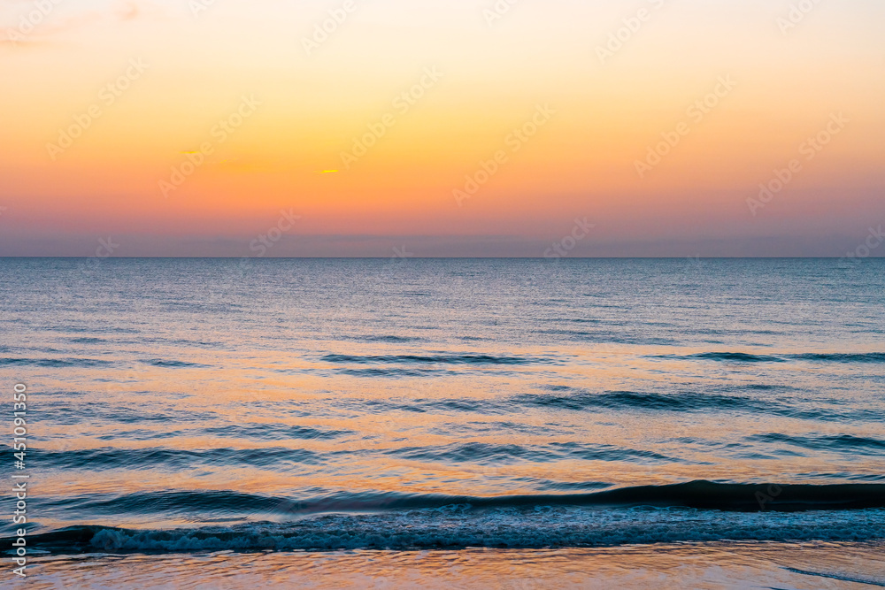 Beautiful sunset colors reflected in the waves of Indian River, Florida