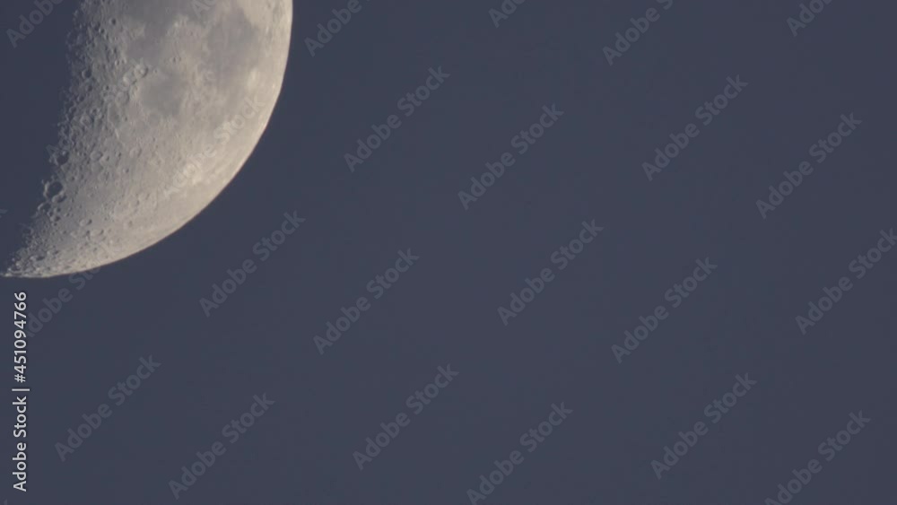 Half moon moving on dark blue dusk sky dome in the perigeum just after sun set. Half moon moving on dark blue dusk sky dome in the perigeum just after sun set.