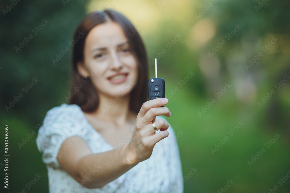 Young beautiful girl holding car keys in hand
