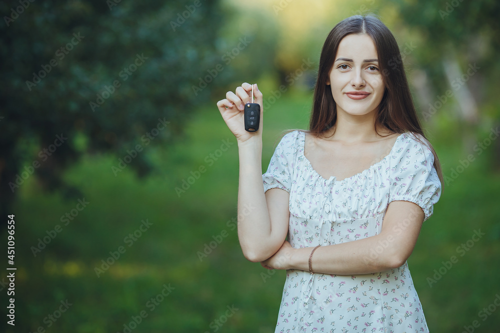 Young beautiful girl holding car keys in hand