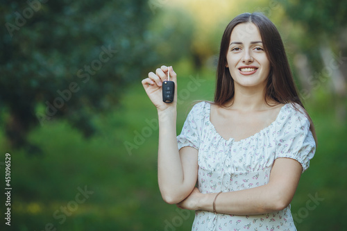 Young beautiful girl holding car keys in hand
