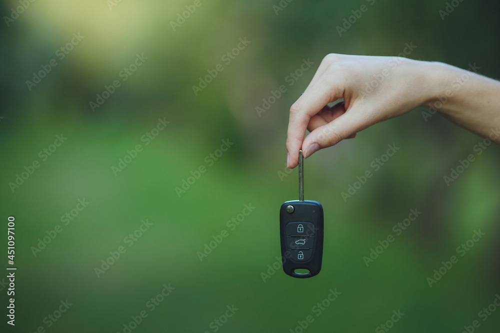 woman holding a car key
