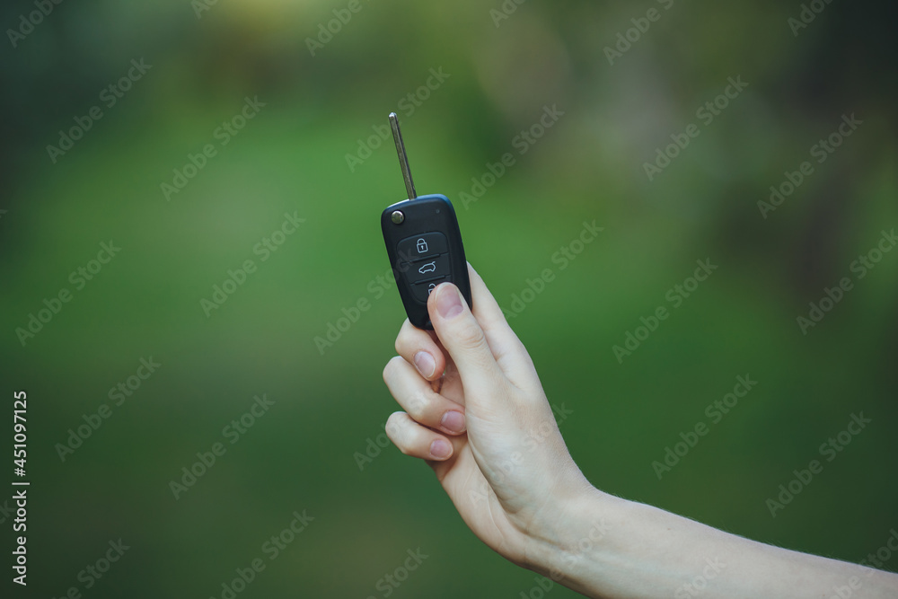 woman holding a car key
