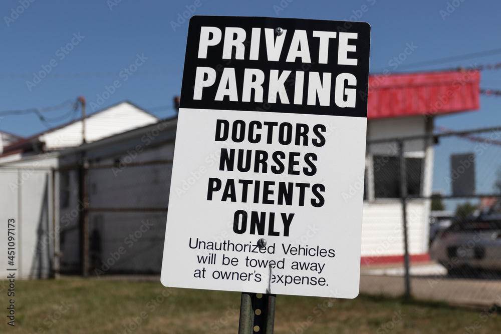 PRIVATE PARKING - DOCTORS NURSES PATIENTS ONLY Sign. A sign that cautions a towed car if you're not a medical professional or patient.
