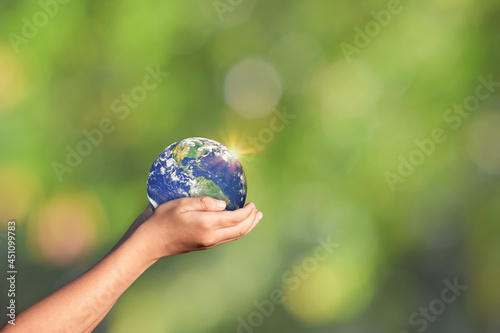 Fototapeta Naklejka Na Ścianę i Meble -  Hands holding Globe, Earth on green nature background. Elements of this image furnished by NASA