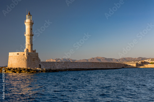 Ancient Venetian lighthouse at the old port of Chania (Crete) in the late evening sunshine