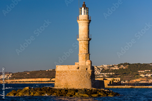 Ancient Venetian lighthouse at the old port of Chania (Crete) in the late evening sunshine
