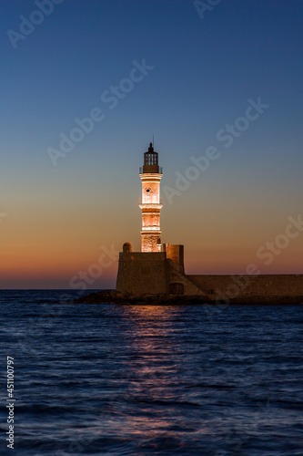 Ancient Venetian lighthouse guarding the old port of Chania  Greece at Sunset