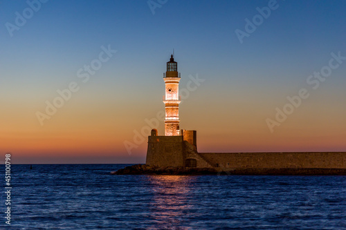 Ancient venetian lighthouse in the Cretan city of Chania at dusk