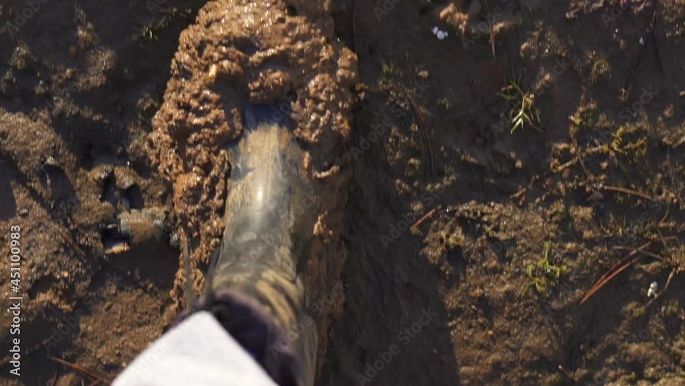 Top view of boots in mud. Close up of hiking legs climbing up rocky trail, dirty shoots. Hikers muddy boots on forest trail. Top view of pair of boots in middle of the mud. Adventure concept. Top view of boots in mud. Close up of hiking legs climbing up rocky trail, dirty shoots. Hikers muddy boots on forest trail. Top view of pair of boots in middle of the mud. Adventure concept.