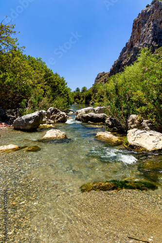 Nautral palm grove and river in a mountainous valley at Preveli, Crete, Greece