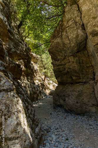 A narrow gorge and dry riverbed in a hot climate (Imbros Gorge, Crete, Greece)