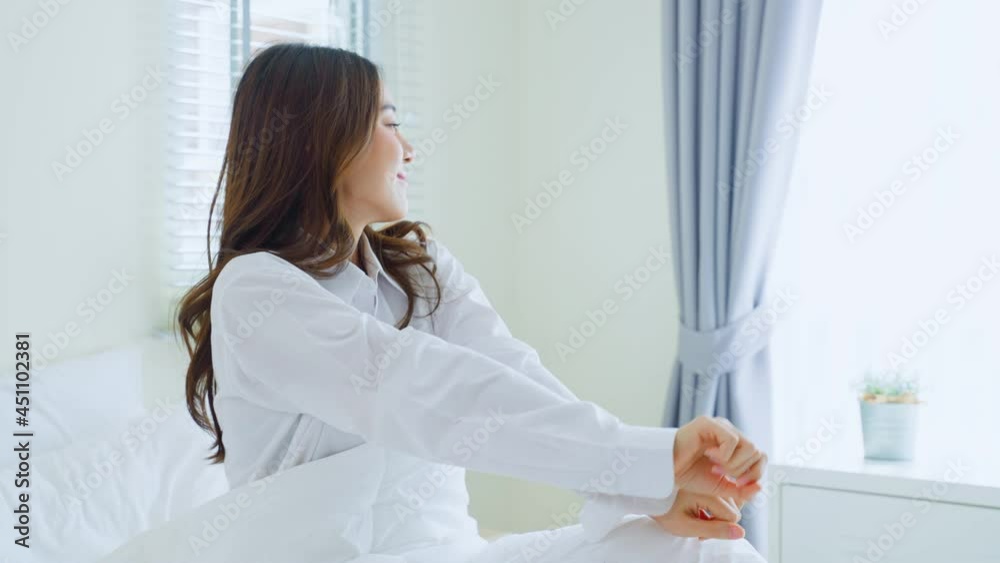 Asian beautiful girl in pajamas wake up in the morning with happiness. Asian beautiful girl in pajamas wake up in the morning with happiness.