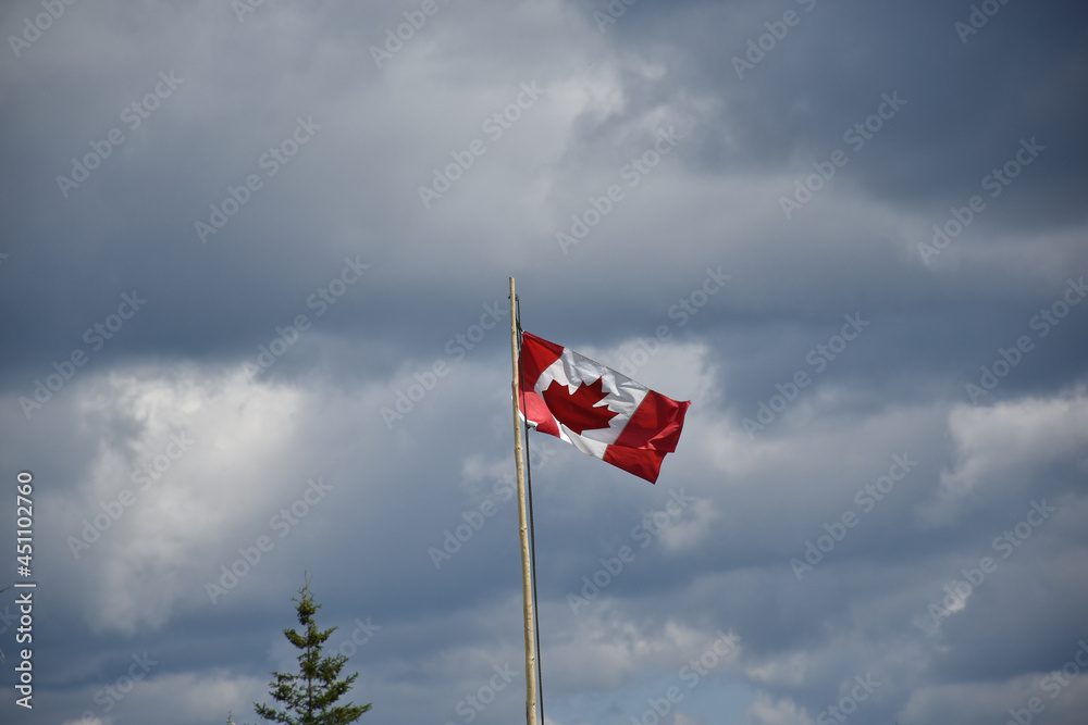 canadian flag waving against clouds canadian flag waving against clouds