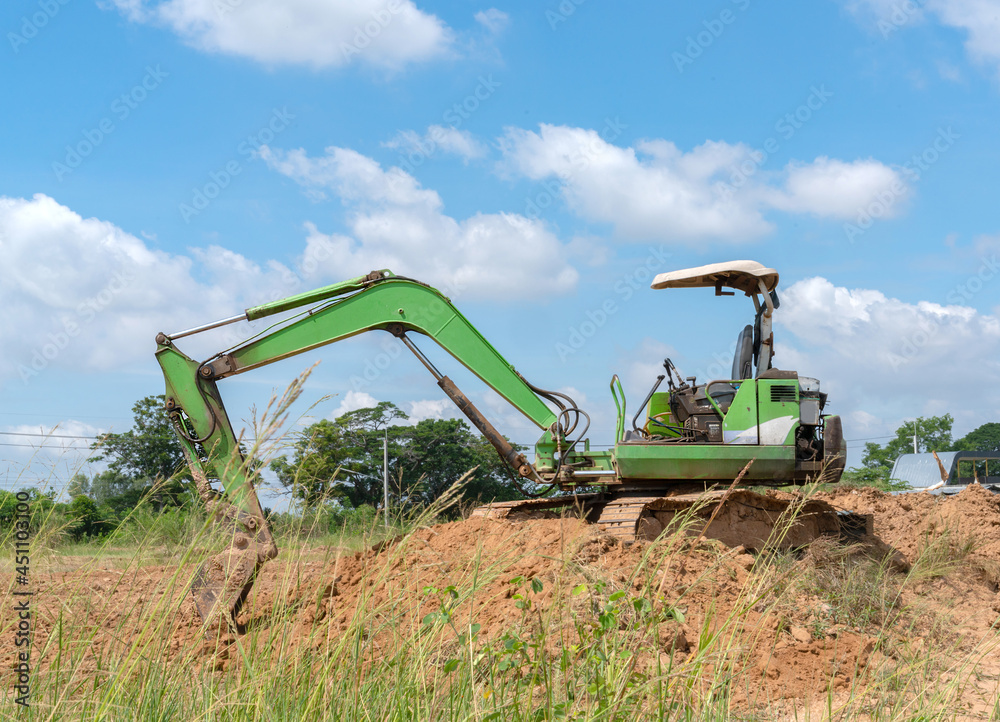 Mini Excavators adjust the soil in construction site. Mini Excavators adjust the soil in construction site.