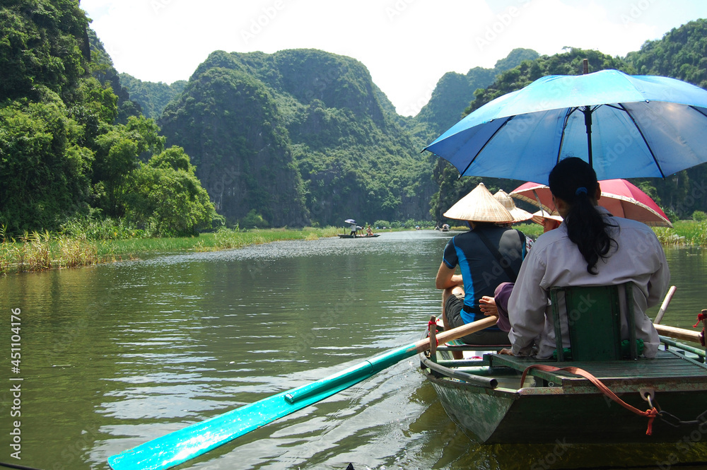 Vietnamese people and foreign traveler travel visit and amazing boat tour trip Tam Coc Bich Dong or Halong Bay on Land and Ngo Dong river and cave of limestone mountains at Ninh Binh in Hanoi, Vietnam