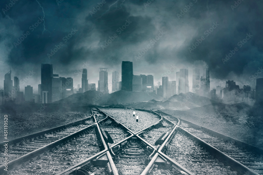 Fototapeta premium Empty railroads with gloomy cityscape background
