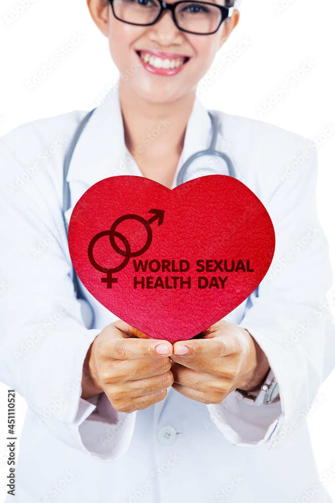 Female doctor holding world sexual health day text Female doctor holding world sexual health day text