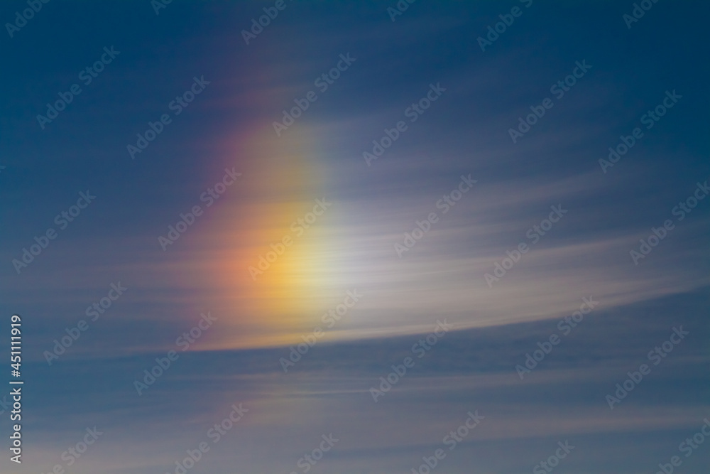 bright beautiful rainbow glows in the clear sky on an early summer morning at dawn