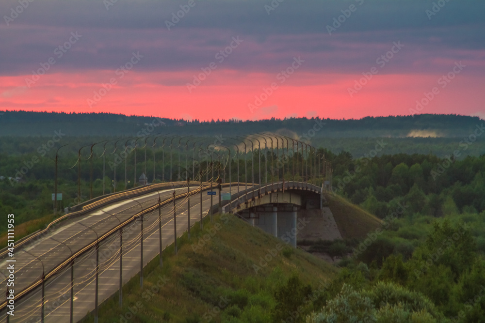 beautiful summer dawn illuminates the humpback road bridge