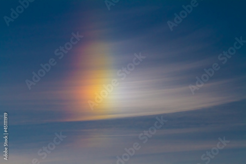 bright beautiful rainbow glows in the clear sky on an early summer morning at dawn