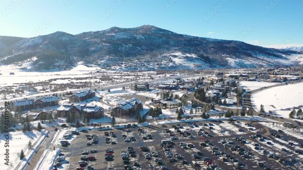 Aerial View Of Full Parking Lot at Steamboat Springs Ski Resort In Colorado At Winter. Most Populous Municipality Of Routt County In The United States. static drone shot Aerial View Of Full Parking Lot at Steamboat Springs Ski Resort In Colorado At Winter. Most Populous Municipality Of Routt County In The United States. static drone shot