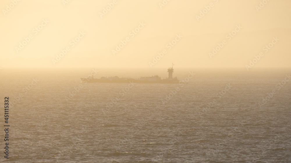 Lone Barge Moving Slowly Along Hazy Shoreline Lone Barge Moving Slowly Along Hazy Shoreline