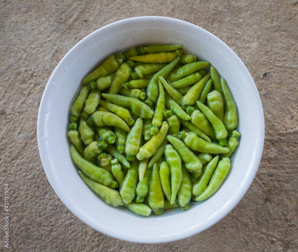 Green chilies before eating must be washed in water to remove dirt and pesticides Green chilies before eating must be washed in water to remove dirt and pesticides