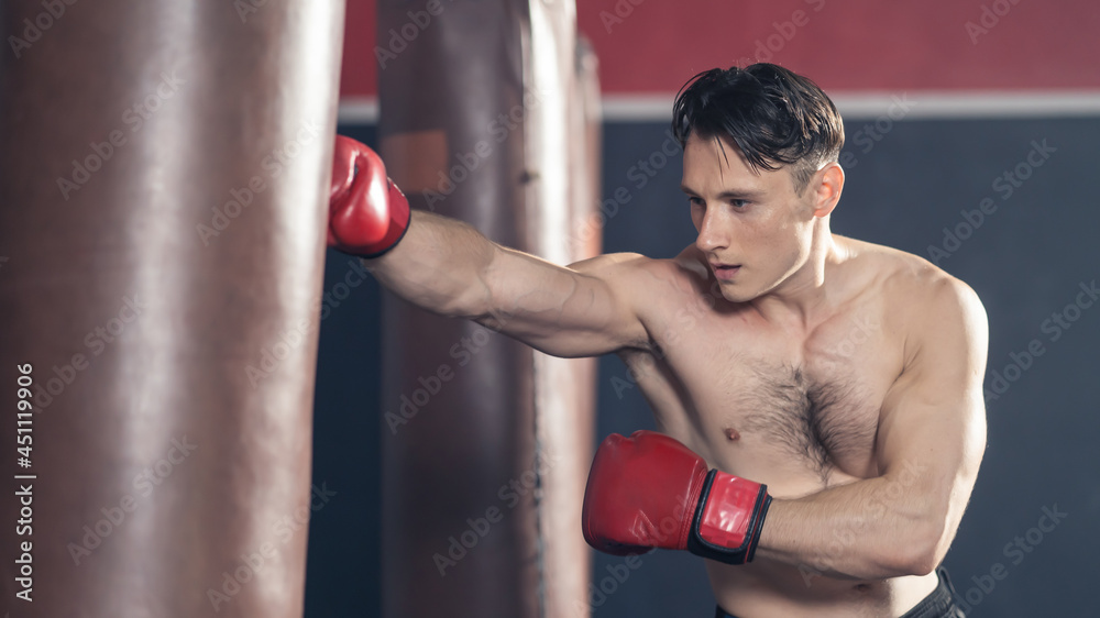 Caucasian sport man in sportswear and boxing glove exercise in fitness