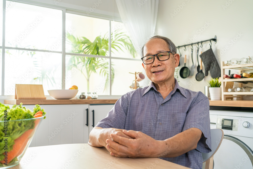 Portrait of Senior male smile and look at camera in kitchen at home. Strong elderly older grandfather wear eyeglasses, feel happy and enjoy retirement life in house. Health care and medical concept. Portrait of Senior male smile and look at camera in kitchen at home. Strong elderly older grandfather wear eyeglasses, feel happy and enjoy retirement life in house. Health care and medical concept.