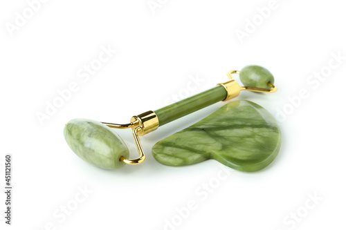 Green facial roller isolated on white background