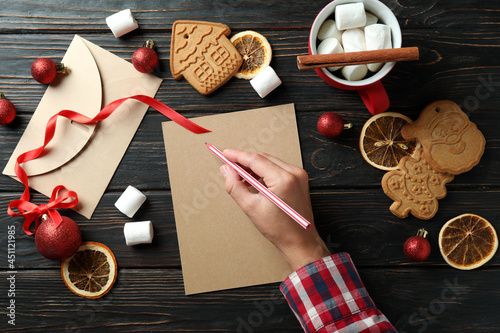 Concept of writing wishlist on wooden table, top view