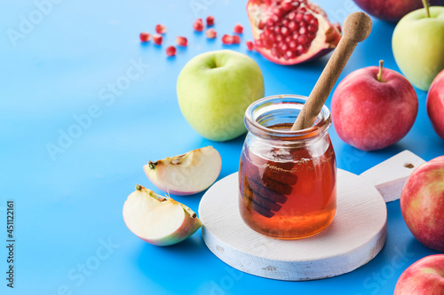 Rosh hashanah jewish New Year holiday concept. Apples, honey, pomegranate photo