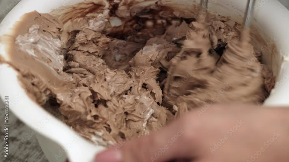 4K Woman pastry chef whips chocolate cream cheese with cream in bowl, close-up. Slow motion. Cake making process 4K Woman pastry chef whips chocolate cream cheese with cream in bowl, close-up. Slow motion. Cake making process