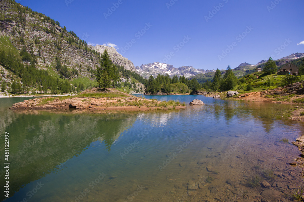 View of idyllic alpine lake with clear water in the summer season, Val Devero, Piedmont, Italy View of idyllic alpine lake with clear water in the summer season, Val Devero, Piedmont, Italy