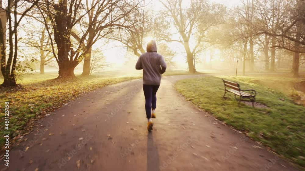 Man jogging in park during sunny autumn morning Man jogging in park during sunny autumn morning