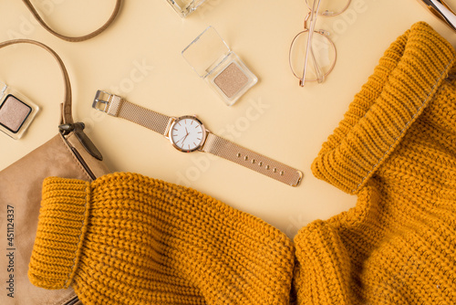 Canvas-taulu Top view photo of yellow sweater leather bag golden wristwatch eyeshadows cosmet