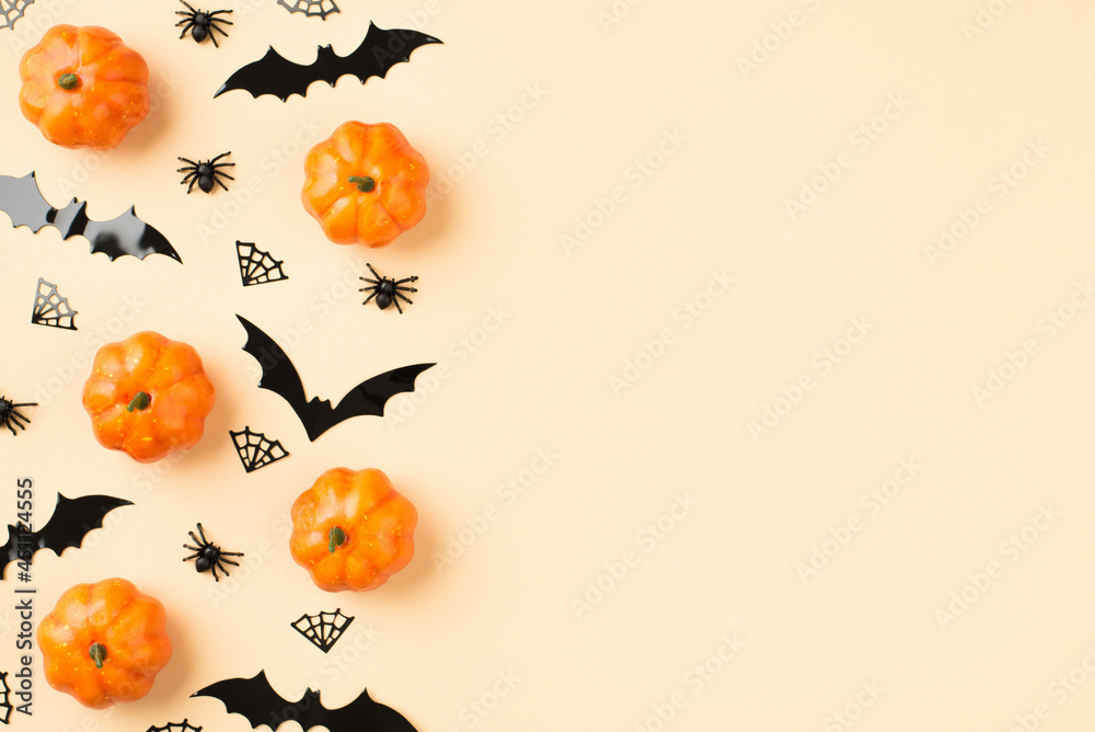 Top view photo of halloween decorations small pumpkins spiders cobweb and bats silhouettes on isolated beige background with copyspace Top view photo of halloween decorations small pumpkins spiders cobweb and bats silhouettes on isolated beige background with copyspace