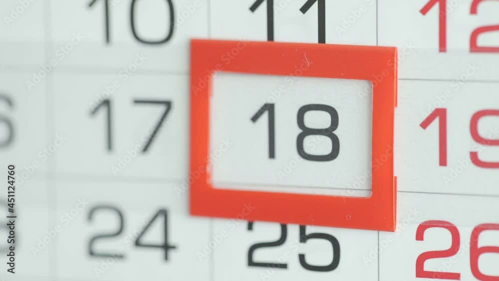 Close-up of a woman's finger moves the date pointer on the calendar Close-up of a woman's finger moves the date pointer on the calendar